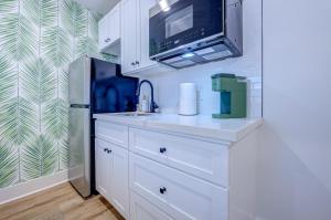 a kitchen with a sink and a refrigerator at Beach House Paradise Studio Apartment 2 Beds in Galveston