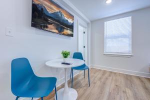 a dining room with a white table and blue chairs at Beach House Paradise Studio Apartment 2 Beds in Galveston