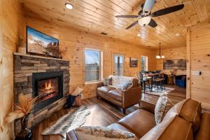 a living room with a fireplace and a dining room at Entire cabin in Sevierville, Tennessee in Sevierville