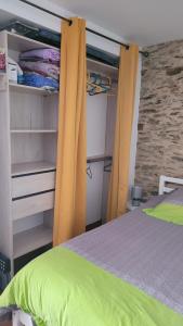 a bedroom with yellow curtains next to a bed at Au cœur de Pornic in Pornic