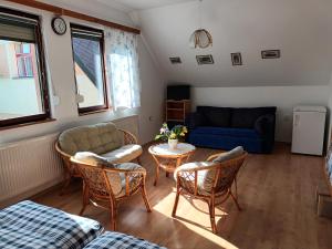 a living room with a couch and a table and chairs at Apartmán Barbora in Turnov