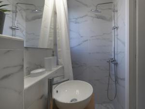 a white bathroom with a sink and a shower at Acropolis View top floor apartment in Athens