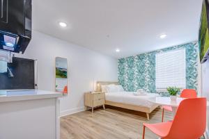 a living room with a bed and a table with chairs at Caribbean Sea Studio Apartment in Galveston