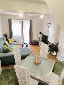 a living room with a table and chairs and a couch at Apartment View in Split