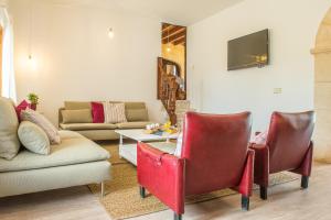 a living room with a couch and a table and chairs at Sant llorens - 4341-21 Mallorca in Sant Llorenç des Cardassar