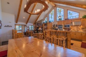 a kitchen with a large wooden table and chairs at Bearfoot Bungalow - Premium and spacious home close to the National Forest and The Village! in Big Bear Lake