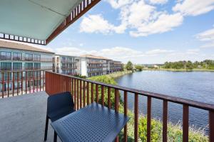 a balcony with a table and a view of a river at All Suites La Teste – Bassin d’Arcachon in La Teste-de-Buch