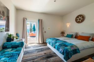 a bedroom with two beds and a window at Seeds of Silence boutique wellbeing hotel near Olhao Faro in Olhão +110 photos