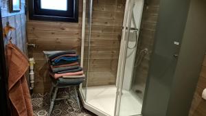 a bathroom with a shower and a pile of towels at Ekornredet (The Squirrel Nest) in Kongsberg