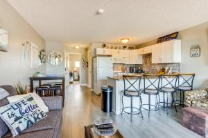 a living room with a couch and a kitchen at Osage Beach Vacation Rental with Pool and Lakeview! in Osage Beach