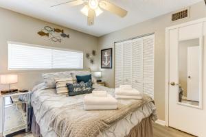 a bedroom with a bed with a ceiling fan at Osage Beach Vacation Rental with Pool and Lakeview! in Osage Beach