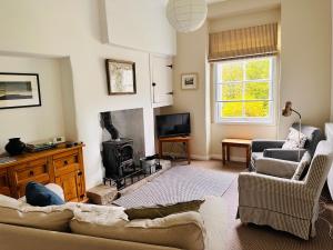 a living room with a couch and a fireplace at Apple Tree Cottage in Marske