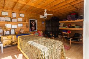 a bedroom with a bed and a wooden ceiling at Seeds of Silence boutique wellbeing hotel near Olhao Faro in Olhão