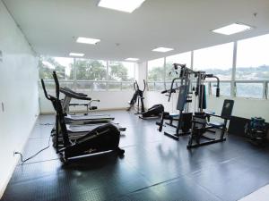 a gym with treadmills and exercise bikes in a room at Hotel Las Olas Bello in Machado