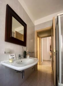 a bathroom with a sink and a mirror on the wall at Cala di Rio B&B in Termoli
