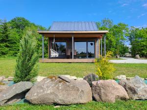 a small house with rocks in the yard at Jaanilille Tinytalo-Sauna in Tahula