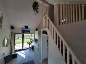 a staircase in a house with a stair case at Jaanilille Tinytalo in Tahula