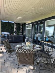 patio ze stołem i krzesłami na ganku w obiekcie Saanichton Waterfront 2BR suite with superb views w mieście Saanichton