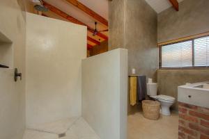 a bathroom with a toilet and a sink at Ibhubesi house in Marloth Park +27 photos