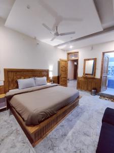 1 dormitorio con 1 cama grande y TV en Delight Homestay Kasol en Kasol