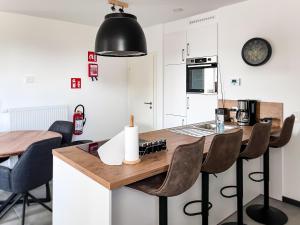 a kitchen with a wooden table and chairs in a room at Hof Gemehret in Eupen
