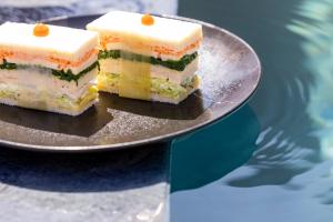 two pieces of cake on a plate on a table at Les Regalia Hôtel & Spa in Sainte-Lucie de Porto-Vecchio