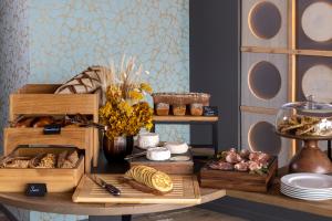 a table with different types of bread and pastries at Les Regalia Hôtel & Spa in Sainte-Lucie de Porto-Vecchio