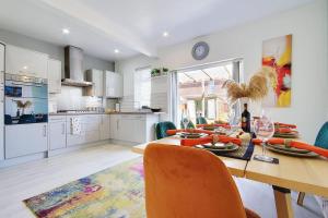 a kitchen and dining room with a table and chairs at SeaEsta Holiday Stay with Game Room EV Point Family friendly in Bournemouth