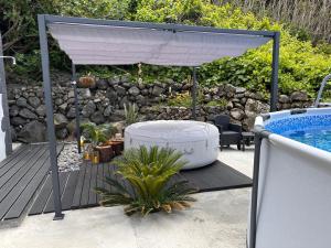 a white canopy over a deck next to a swimming pool at Spot Milasmar in Faja Grande