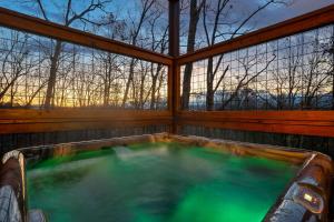 a jacuzzi tub in a house with trees at Entire cabin in Sevierville, Tennessee in Sevierville