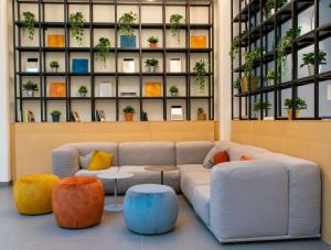 a living room with a couch and colorful ottools at S4 Stays in Florence