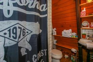 a bathroom with a toilet and a sign on the wall at Bills Big Bear Bunkhouse - Beautiful home within a short drive to all Big Bear has to offer! in Big Bear City +8 photos