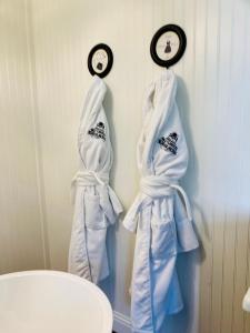 two towels hanging on a wall with a clock at The Old Liberty Schoolhouse in Azle