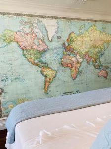 a large map of the world hanging on a wall at The Old Liberty Schoolhouse in Azle