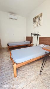 a bedroom with two beds in a room at HOTEL AMAZ in Ribeirão Preto