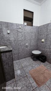 a bathroom with a shower and a toilet in it at HOTEL AMAZ in Ribeirão Preto
