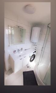 a white bathroom with a sink and a mirror at Two bedroom apartment Bambi in Vir