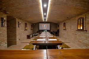 a long row of tables in a brick room at Residence Malva in Valtice