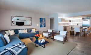 a living room with a blue couch and a table at Incredible Ocean Views! Terrace, 1800 sq.ft., Hotel in Miami Beach