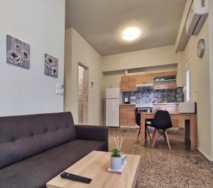 a living room with a couch and a table at GARNET 3 in Kalamata