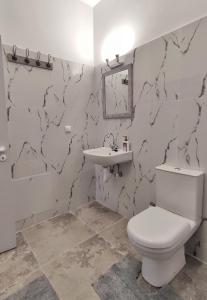 a bathroom with a toilet and a sink at GARNET 3 in Kalamata +9 photos