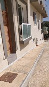 a building with a balcony on the side of it at Luxury en-suite Double. Beach-house with Sea Views in Mellieħa