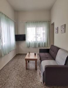 a living room with a couch and a coffee table at GARNET 3 in Kalamata