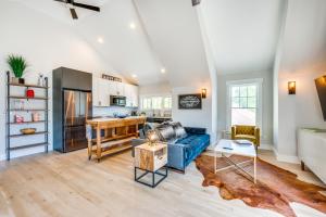 a living room with a blue couch and a kitchen at Westminster Vacation Rental about 15 Mi From Denver in Westminster