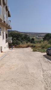 an empty parking lot in front of a building at Luxury en-suite Double. Beach-house with Sea Views in Mellieħa