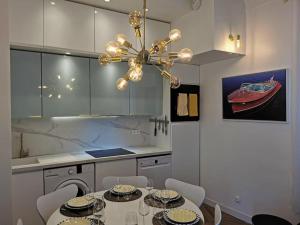 a kitchen with a dining table and a chandelier at Vista Monaco, 5mn walk to Monaco, Amazing view in Beausoleil