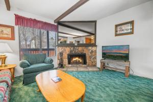 a living room with a couch and a fireplace at Boulder Bay Chalet Condo - Mountain charm condo with lake view and WIFI! in Big Bear Lake