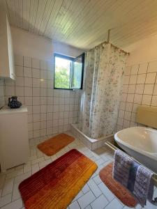 a bathroom with a tub and a shower and a sink at DOLCE NOTTE rooms in Virpazar