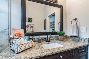 a bathroom with a sink and a mirror at Cozy Urban Haven in Historic Ybor - Close downtown in Tampa