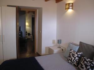 a bedroom with a bed and a hallway with a lamp at Casa do Castelo - Muralha in Castelo de Vide